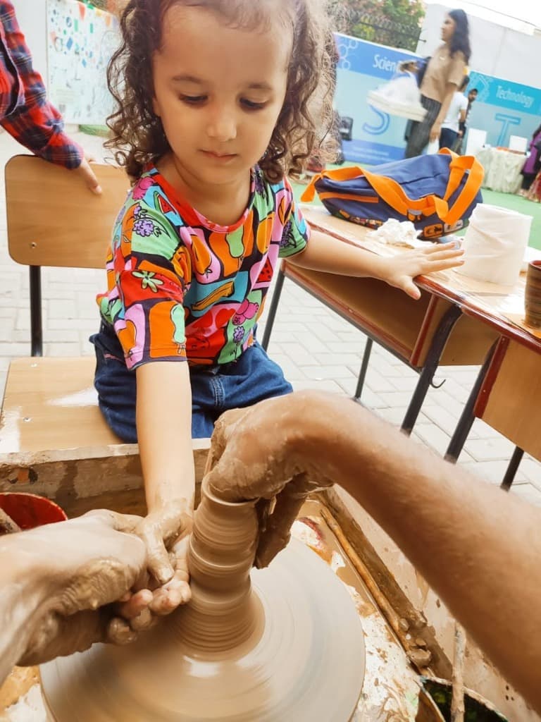 Students learning clay pottery with teachers